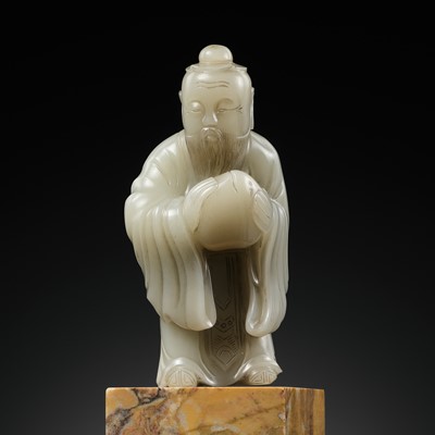 Lot 455 - A PALE CELADON JADE FIGURE OF A DONGFANG SHUO, 17TH TO 18TH CENTURY