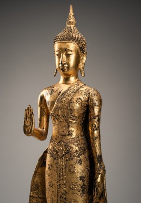 Lot 1058 - A TALL GILT-LACQUER BRONZE FIGURE OF BUDDHA, RATTANAKOSIN KINGDOM