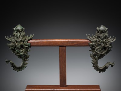 Lot 683 - A FINE PAIR OF BRONZE PALANQUIN HOOKS, KHMER EMPIRE, ANGKOR PERIOD, BAYON STYLE