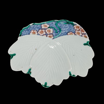 Lot 183 - A RARE AND EARLY NABESHIMA PORCELAIN LEAF-FORM ‘IVY’ DISH WITH PLUM BLOSSOMS, WITH AUTHENTICATION BY IMAIZUMI MOTOSUKI