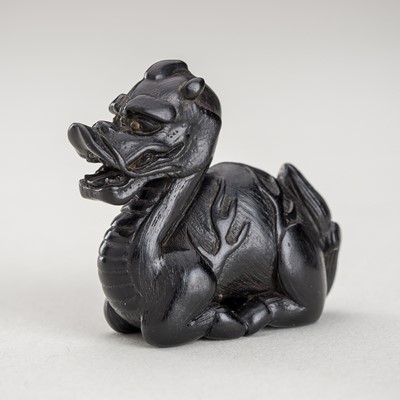 Lot 1349 - A SMALL EBONY WOOD NETSUKE OF KIRIN