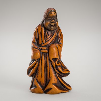 Lot 1350 - A WOOD NETSUKE OF OKAME