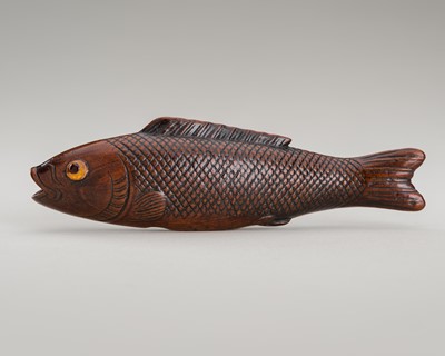 Lot 1339 - SANSHO: A WOOD NETSUKE OF A FISH WITH INLAID EYES