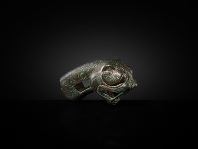 Lot 112 - A TURQUOIZE- AND SILVER-INLAID BRONZE ‘TIGER’ FINIAL, EASTERN HAN DYNASTY