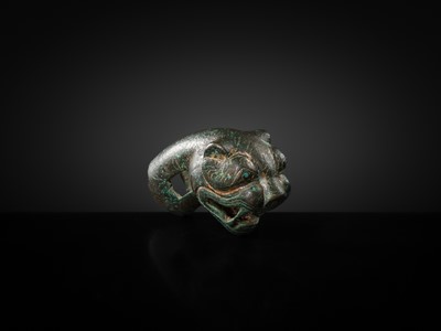 Lot 112 - A TURQUOIZE- AND SILVER-INLAID BRONZE ‘TIGER’ FINIAL, EASTERN HAN DYNASTY
