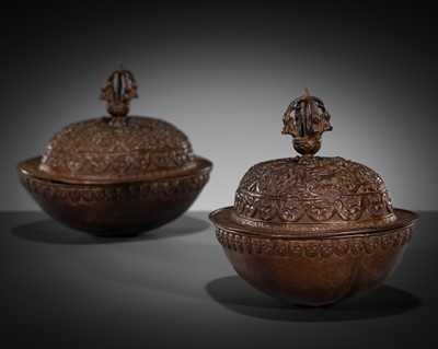 Lot 6 - A PAIR OF COPPER REPOUSSÉ ‘BAJIXIANG’ KAPALAS AND COVERS, TIBET, 18TH-19TH CENTURY