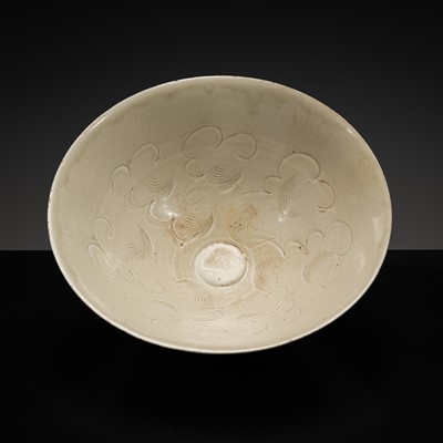 Lot 546 - A CARVED QINGBAI ‘CLOUD SCROLL’ BOWL, NORTHERN SONG DYNASTY