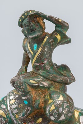 Lot 1568 - AN INLAID BRONZE FIGURE OF A CAMEL WITH RIDER, TANG DYNASTY