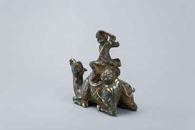 Lot 1568 - AN INLAID BRONZE FIGURE OF A CAMEL WITH RIDER, TANG DYNASTY