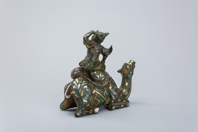 Lot 1568 - AN INLAID BRONZE FIGURE OF A CAMEL WITH RIDER, TANG DYNASTY