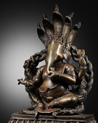 Lot 203 - A LARGE BRASS FIGURE OF GANESHA BENEATH A NAGA HOOD, WESTERN HIMALAYAS, 16TH-17TH CENTURY