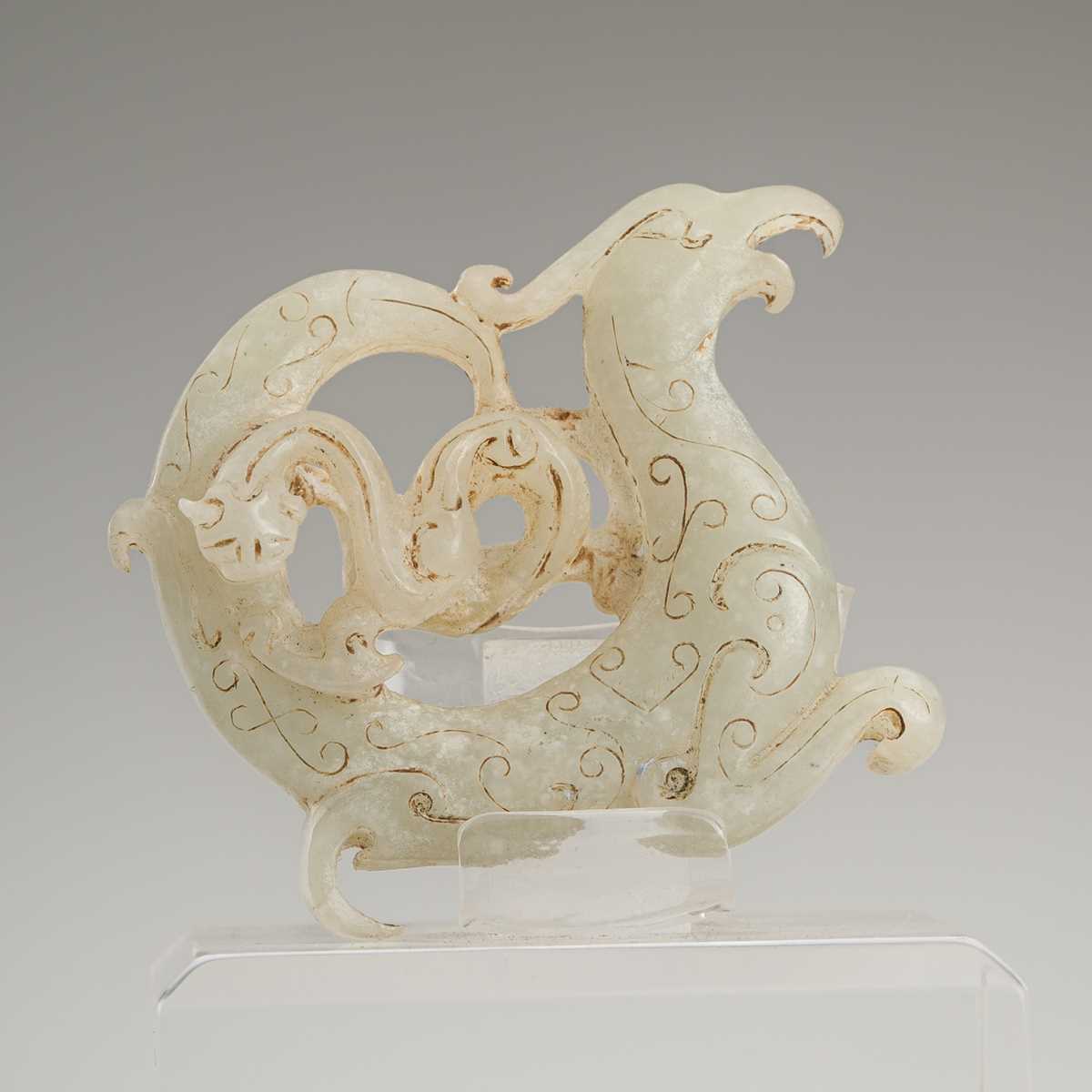 Lot 812 - A CELADON JADE 'PHOENIX AND DRAGON' PENDANT,