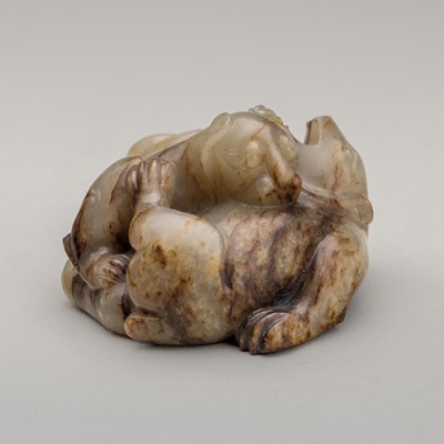 Lot 818 - A PALE CELADON AND RUSSET JADE ‘BEAR AND TIGER’ MAT WEIGHT, MING DYNASTY