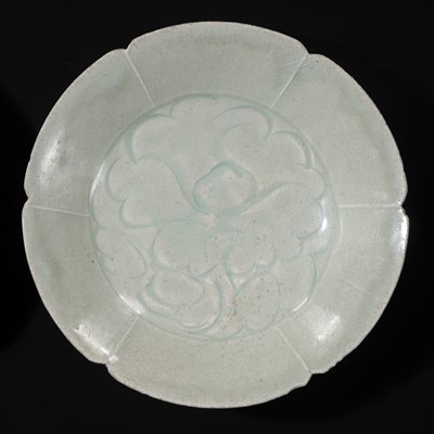 Lot 495 - TWO CARVED FLORIFORM QINGBAI ‘PEONY’ DISHES, SONG DYNASTY