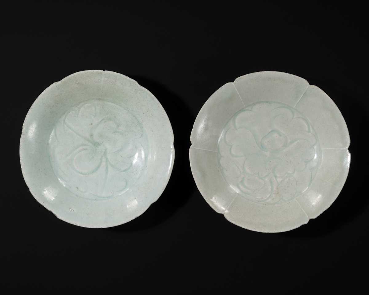 Lot 495 - TWO CARVED FLORIFORM QINGBAI ‘PEONY’ DISHES, SONG DYNASTY