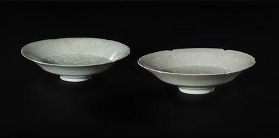 Lot 495 - TWO CARVED FLORIFORM QINGBAI ‘PEONY’ DISHES, SONG DYNASTY