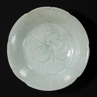 Lot 495 - TWO CARVED FLORIFORM QINGBAI ‘PEONY’ DISHES, SONG DYNASTY