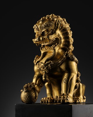 Lot 389 - A FINE GILT BRONZE FIGURE OF A BUDDHIST LION, 19TH CENTURY OR EARLIER