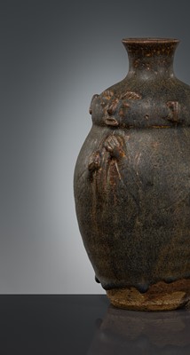 Lot 355 - A BROWN-GLAZED HUMANOID STONEWARE JAR, ANGKOR PERIOD