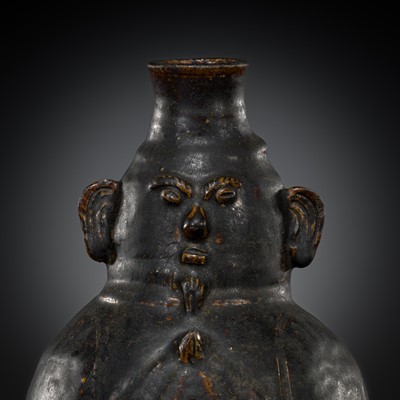 Lot 684 - A BROWN-GLAZED STONEWARE JAR WITH A HUMAN FACE, ANGKOR PERIOD