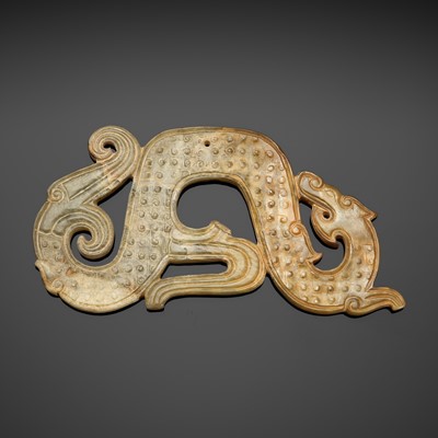 A CELADON AND RUSSET JADE ‘DRAGON’ PENDANT, WARRING STATES PERIOD