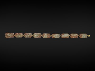 Lot 90 - A CELADON AND RUSSET JADE ‘FOUR GUARDIANS’ BELT, EASTERN HAN DYNASTY