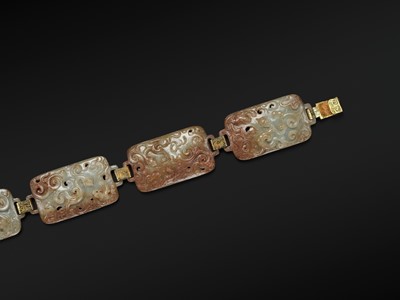 Lot 90 - A CELADON AND RUSSET JADE ‘FOUR GUARDIANS’ BELT, EASTERN HAN DYNASTY