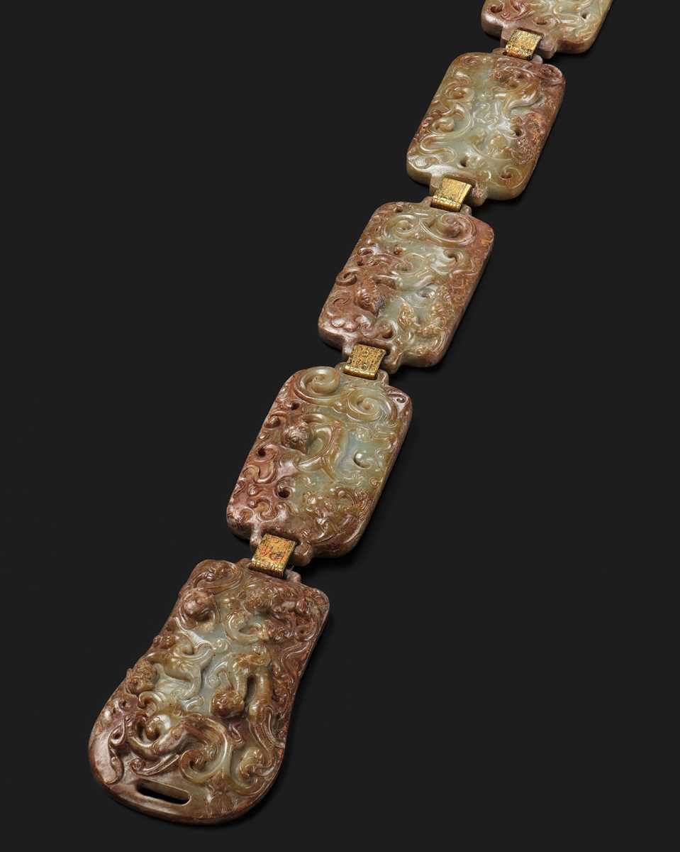 Lot 90 - A CELADON AND RUSSET JADE ‘FOUR GUARDIANS’ BELT, EASTERN HAN DYNASTY