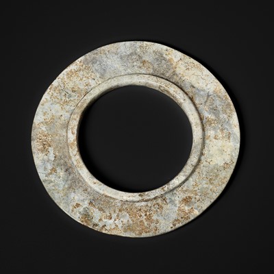 A CALCIFIED JADE COLLARED DISK, SHANG DYNASTY