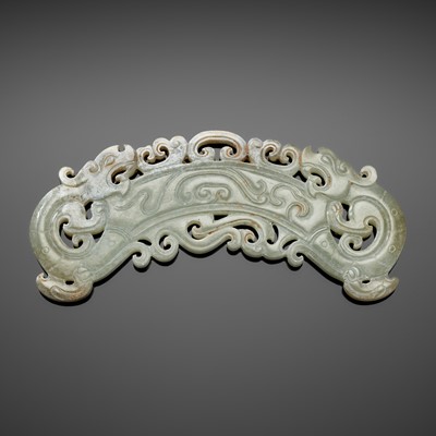 A RETICULATED PALE CELADON JADE ‘DOUBLE-DRAGON’ PENDANT, HUANG, EASTERN HAN DYNASTY