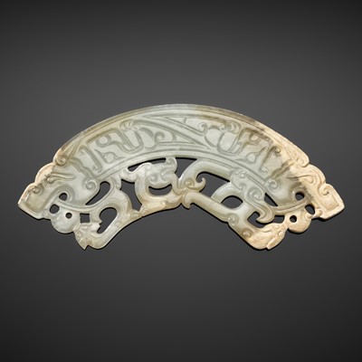 A RARE RETICULATED PALE CELADON JADE ‘DRAGON’ PENDANT, HUANG, EASTERN ZHOU DYNASTY