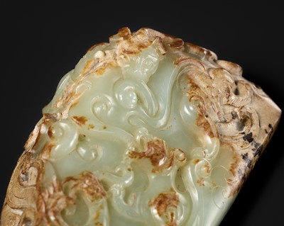 A CELADON AND RUSSET JADE ‘FOUR GUARDIANS’ WEIGHT, EASTERN HAN DYNASTY