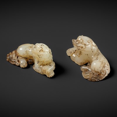 A RARE PAIR OF WHITE JADE BUDDHIST LIONS, HAN DYNASTY