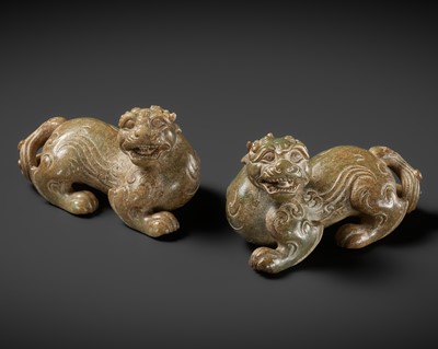 AN IMPORTANT RARE PAIR OF GREEN AND RUSSET JADE BIXIE FIGURES, HAN DYNASTY