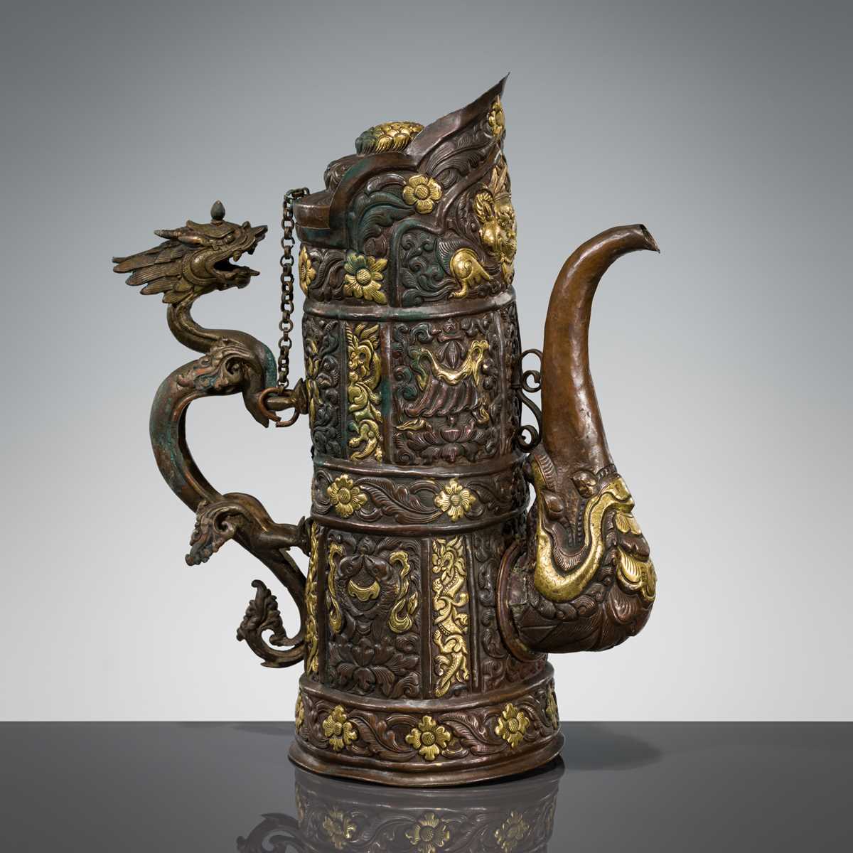 Lot 5 - A PARCEL-GILT COPPER REPOUSSÉ RITUAL EWER, DUOMUHU, TIBET, 19TH CENTURY