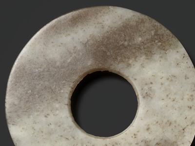 Lot 139 - A MOTTLED WHITE AND RUSSET JADE DISK, BI, QIJIA CULTURE