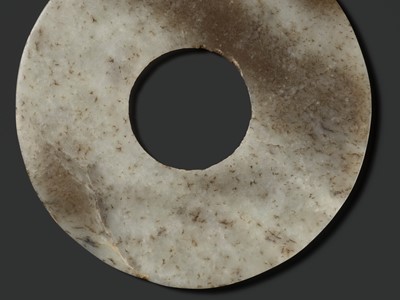 Lot 139 - A MOTTLED WHITE AND RUSSET JADE DISK, BI, QIJIA CULTURE