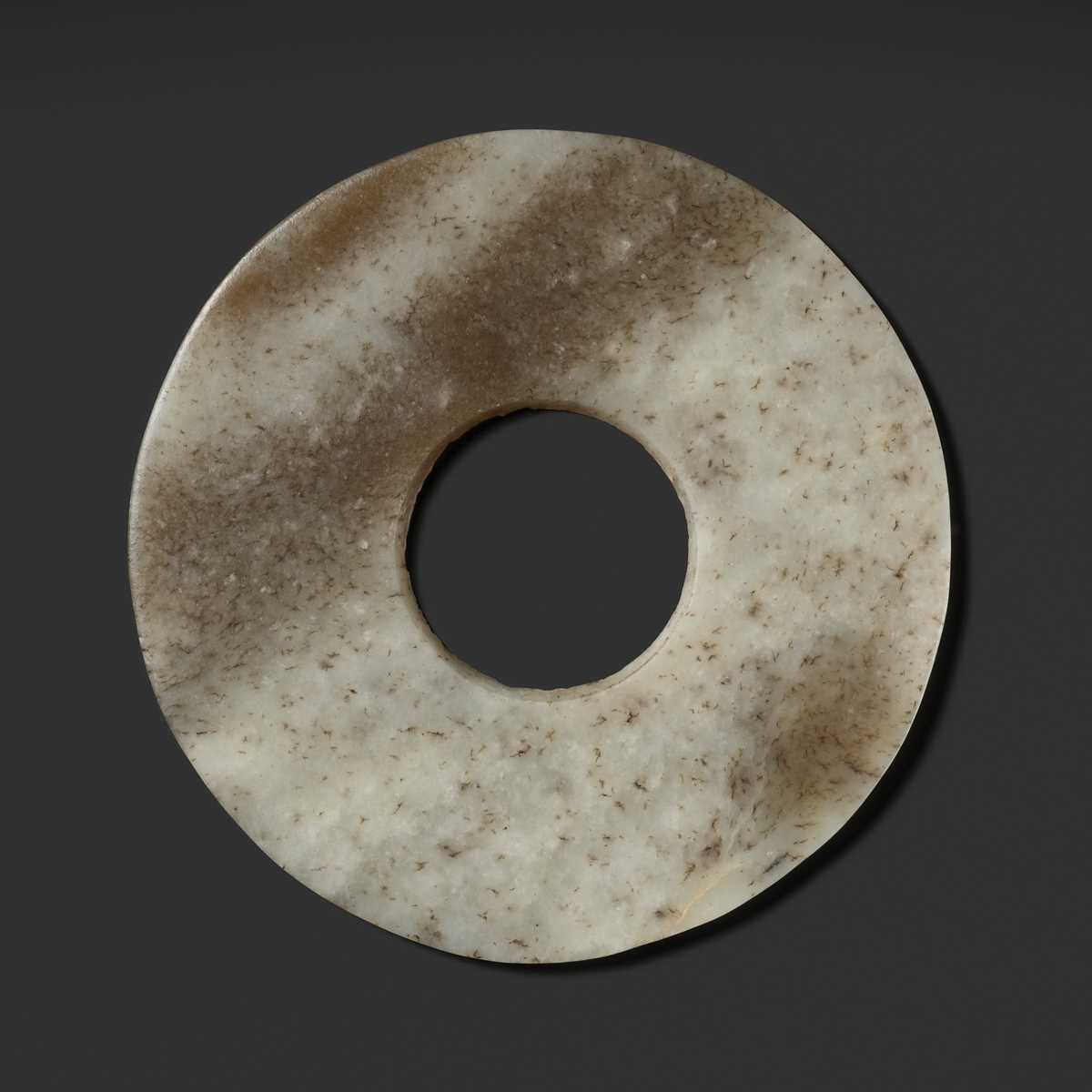 Lot 139 - A MOTTLED WHITE AND RUSSET JADE DISK, BI, QIJIA CULTURE