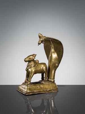Lot 289 - A BRASS FIGURE OF NANDI CANOPIED BY A CROWNED NAGA, INDIA, 17TH CENTURY