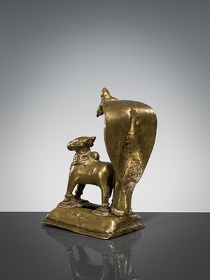 Lot 289 - A BRASS FIGURE OF NANDI CANOPIED BY A CROWNED NAGA, INDIA, 17TH CENTURY