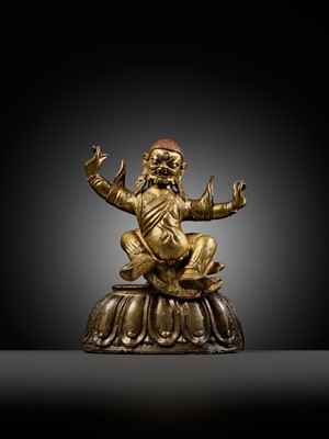 Lot 19 - A GILT-BRONZE FIGURE OF GARWA NAGPO DAMCHEN, TIBET, 17TH-18TH CENTURY