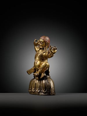 Lot 19 - A GILT-BRONZE FIGURE OF GARWA NAGPO DAMCHEN, TIBET, 17TH-18TH CENTURY