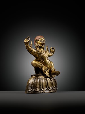 Lot 19 - A GILT-BRONZE FIGURE OF GARWA NAGPO DAMCHEN, TIBET, 17TH-18TH CENTURY