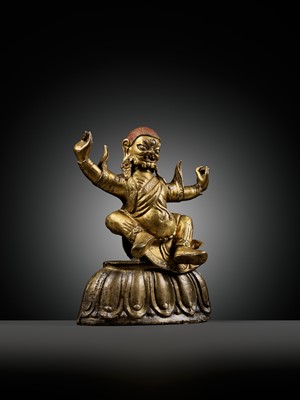 Lot 19 - A GILT-BRONZE FIGURE OF GARWA NAGPO DAMCHEN, TIBET, 17TH-18TH CENTURY