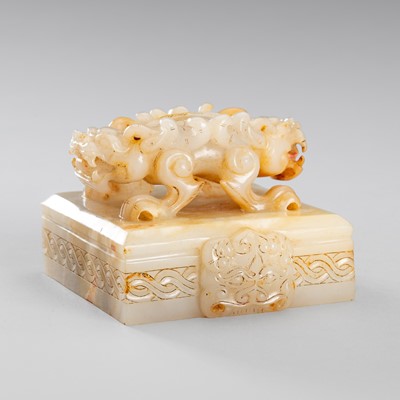 Lot 956 - AN ARCHAISTIC WHITE AND RUSSET JADE ‘DRAGON’ SEAL, QING DYNASTY