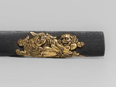 Lot 1607 - A SHAKUDO KOZUKA WITH A PAIR OF SHISHI