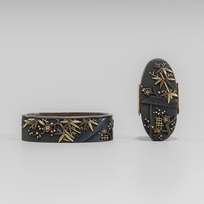 Lot 638 - A SHAKUDO FUCHI AND KASHIRA WITH BAMBOO AND PLUM BLOSSOM