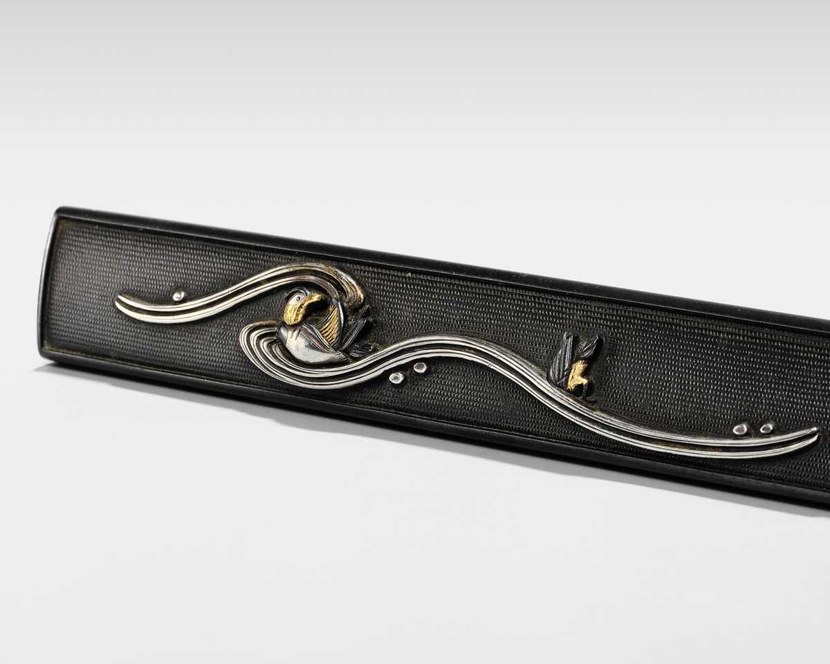 Lot 84 - A SHAKUDO KOZUKA WITH TWO MANDARIN DUCKS (OSHIDORI) IN WAVES