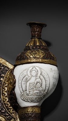 Lot 29 - A CARVED CONCH-SHELL TRUMPET, DUNG DKAR, WITH PARCEL-GILT COPPER REPOUSSÉ MOUNT
