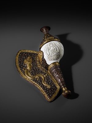 Lot 29 - A CARVED CONCH-SHELL TRUMPET, DUNG DKAR, WITH PARCEL-GILT COPPER REPOUSSÉ MOUNT